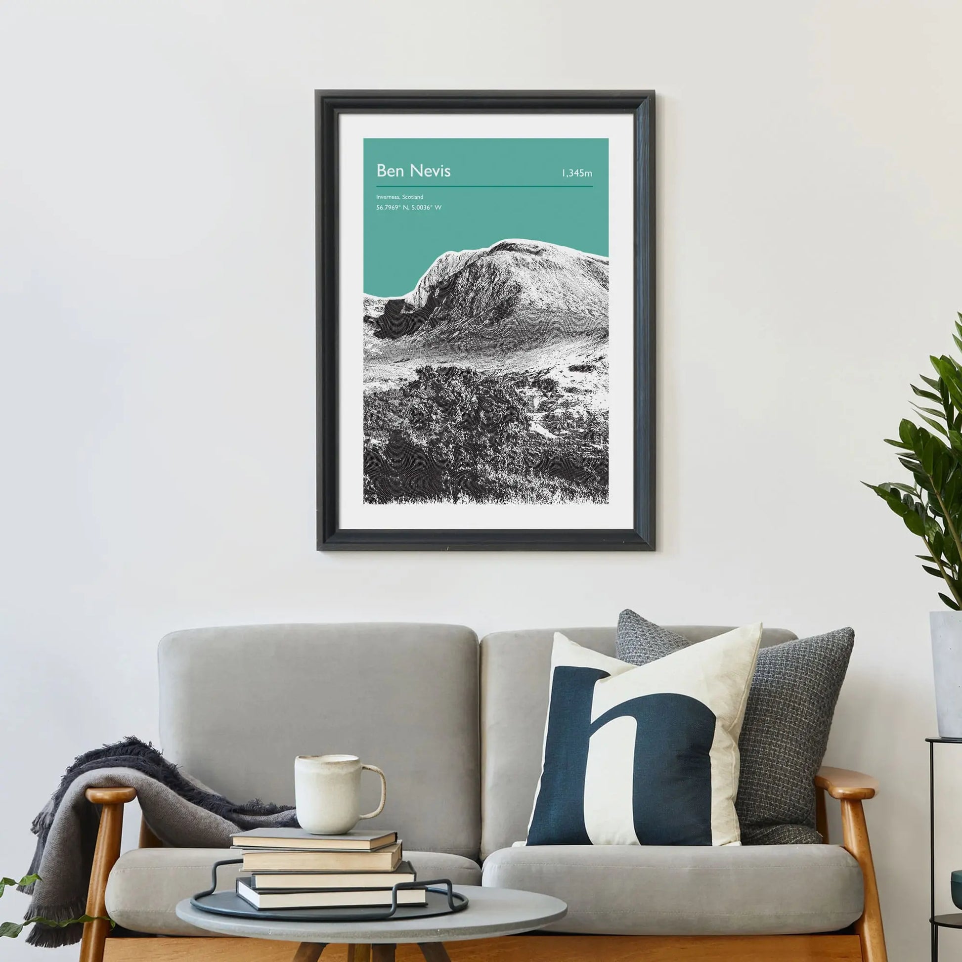 Print framed on wall above a sofa and cushions