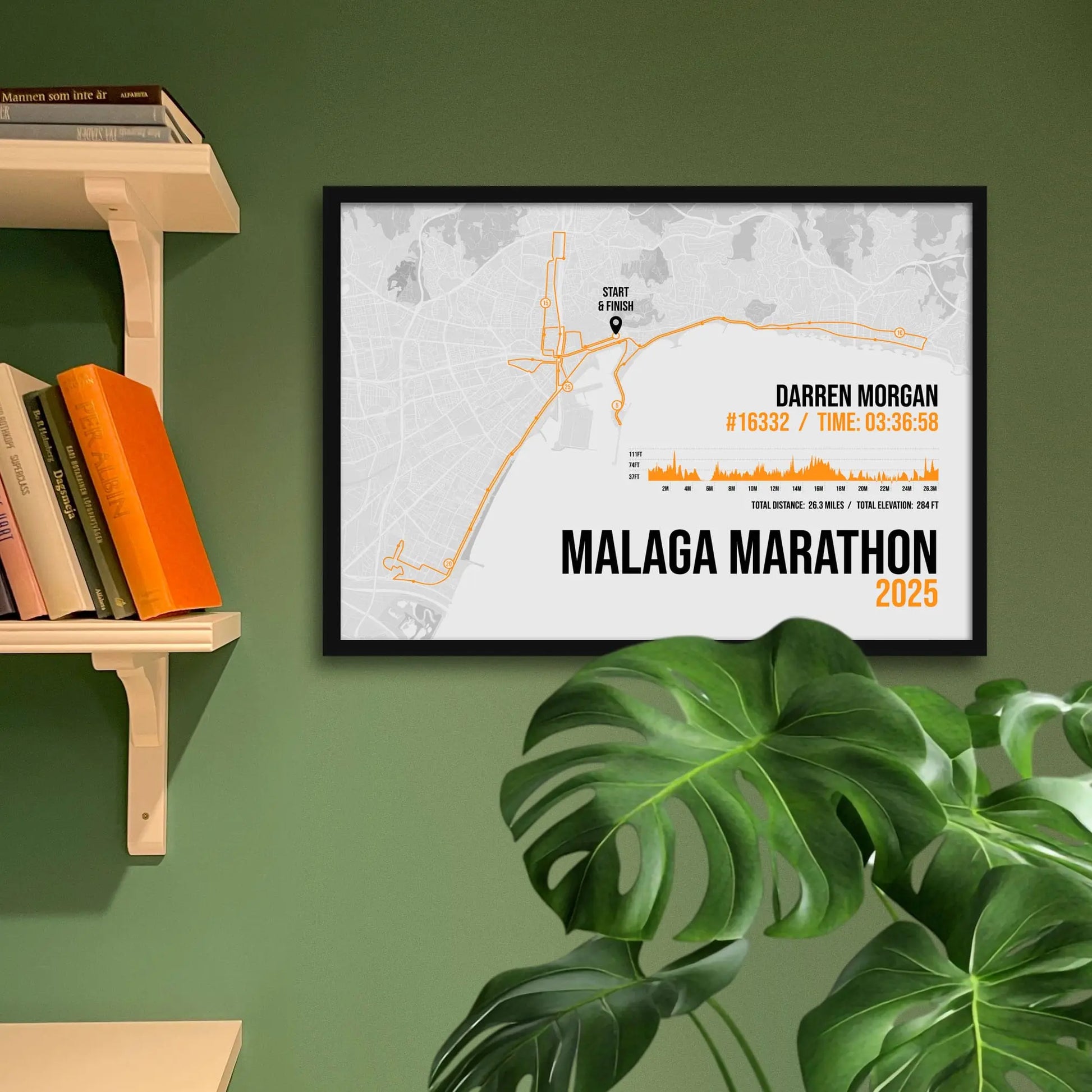 Framed art print on a green wall beside shelves.