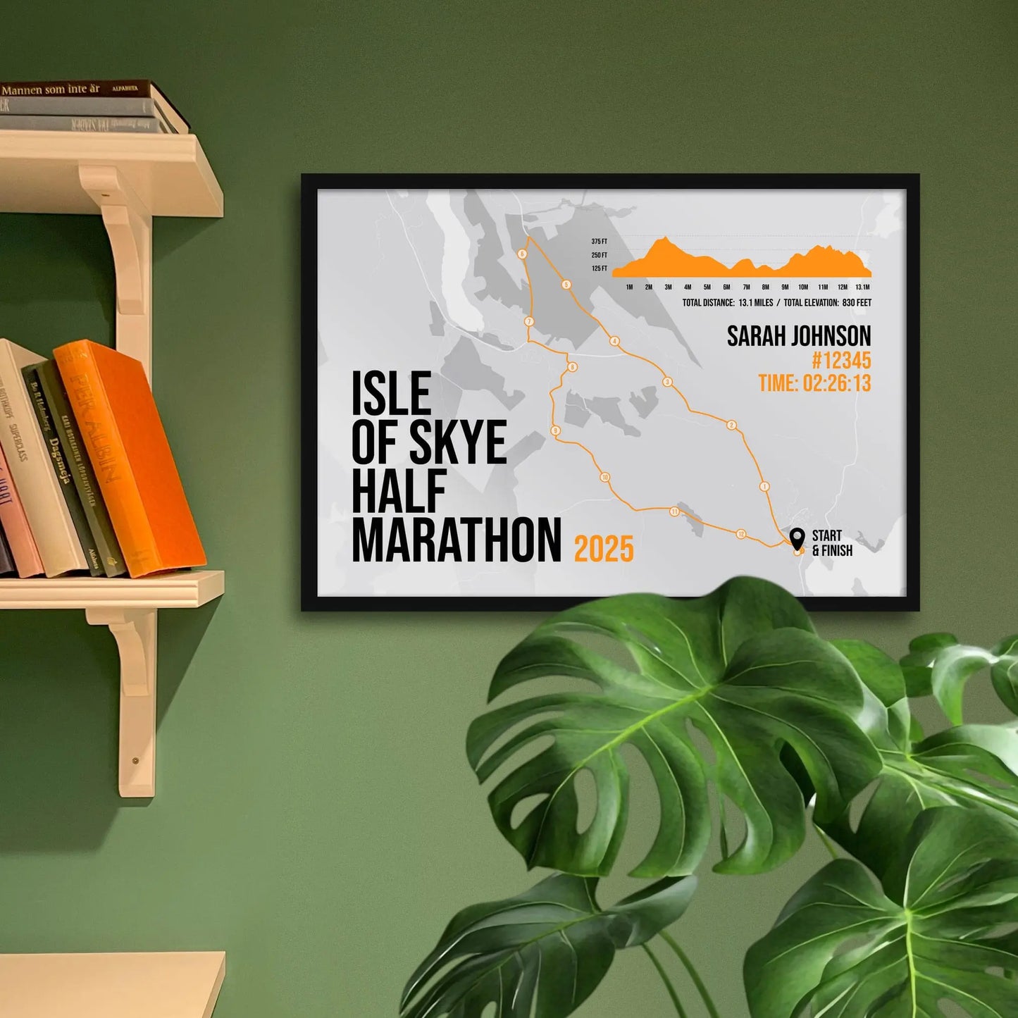 Framed print hanging on green wall beside shelves