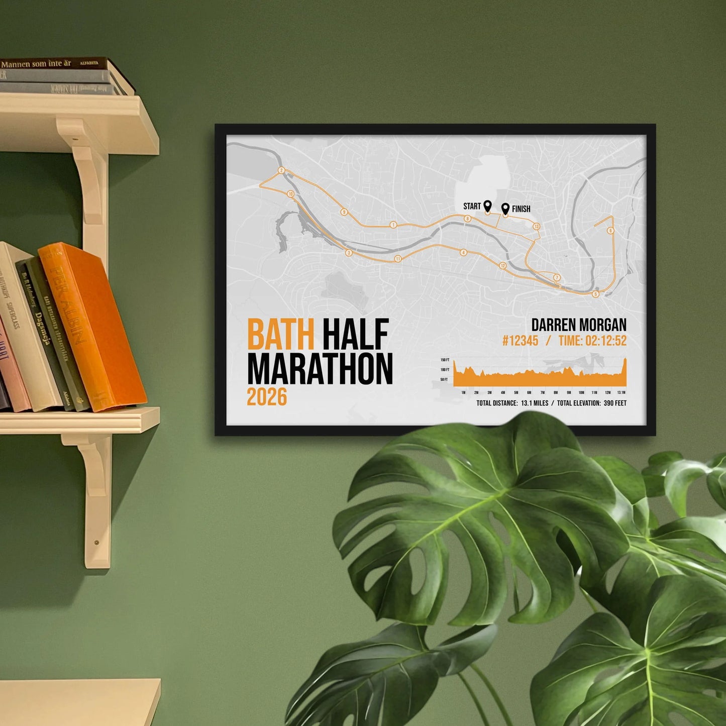 Print framed and in a black frame on a green wall beside some shelves