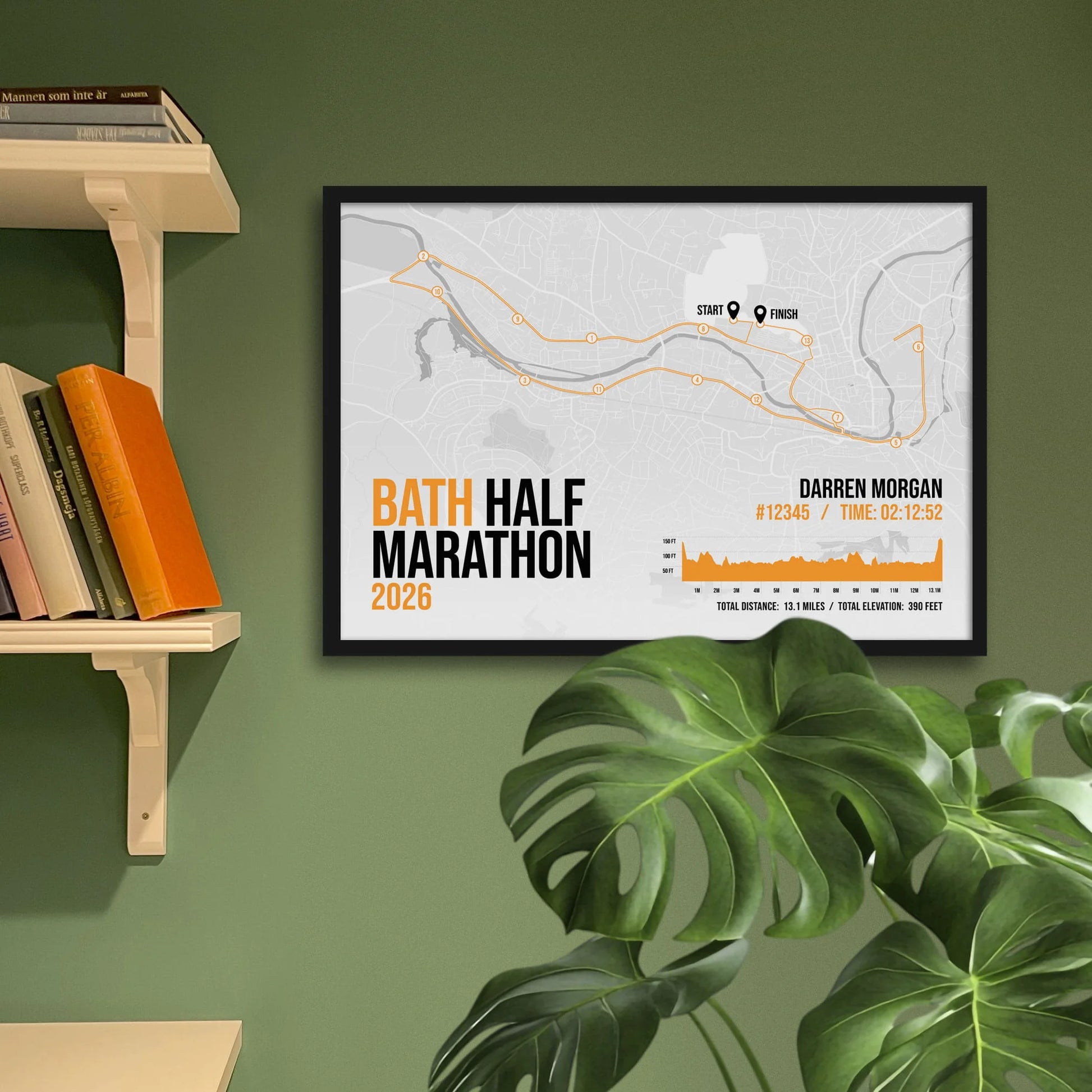 Print framed and in a black frame on a green wall beside some shelves