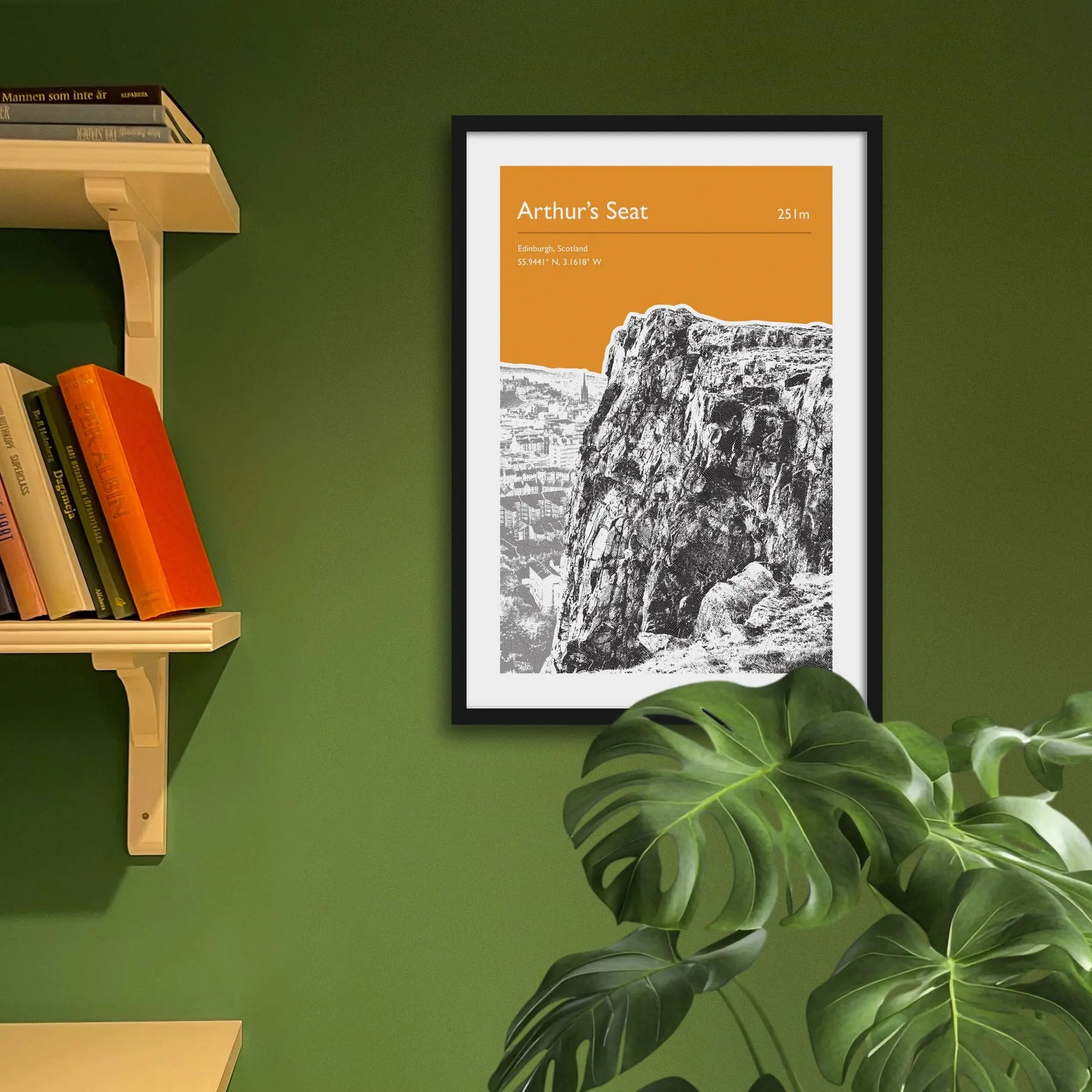 Framed art print on a green wall beside shelves.
