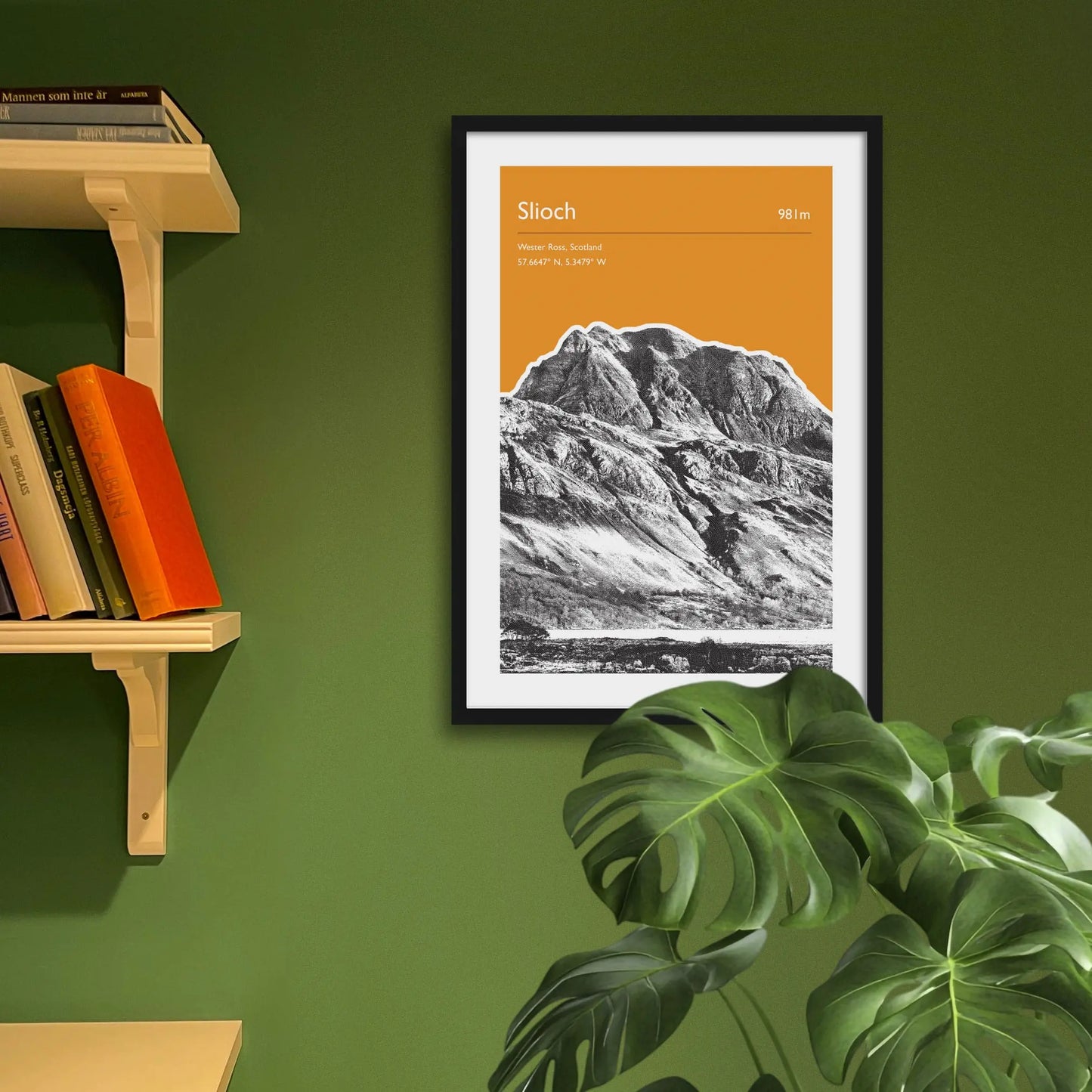Framed art print on a green wall beside shelves.