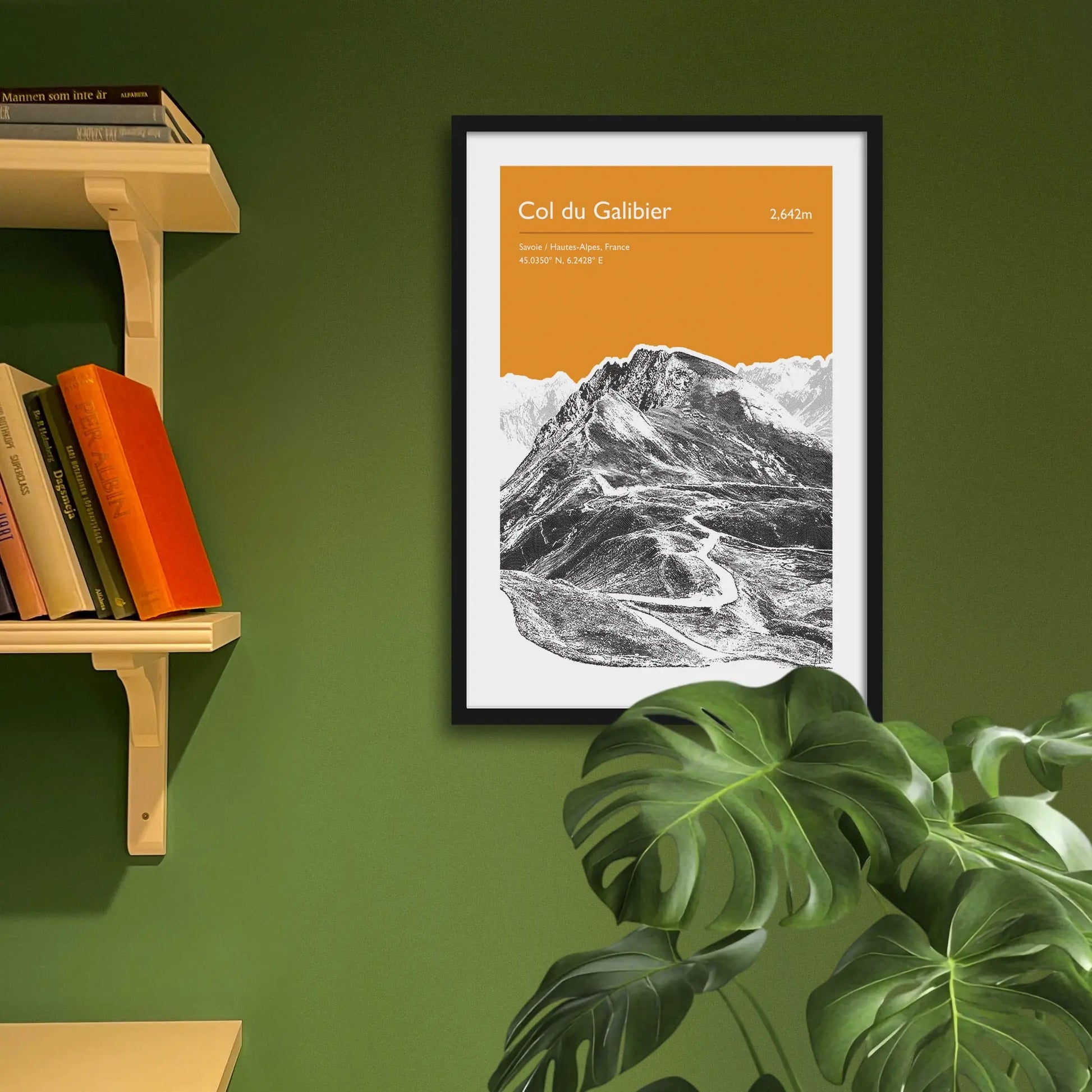 Framed art print on a green wall beside shelves.