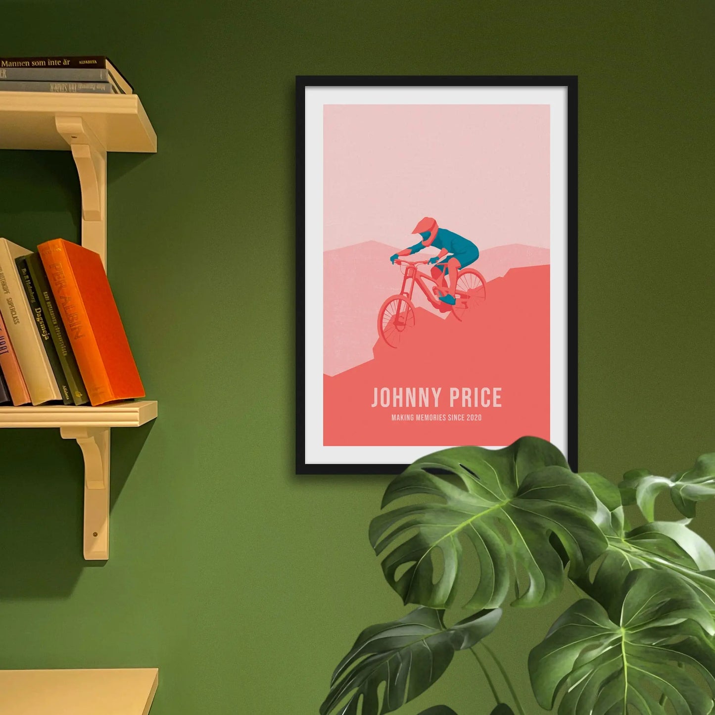 Framed art print on a green wall beside shelves.
