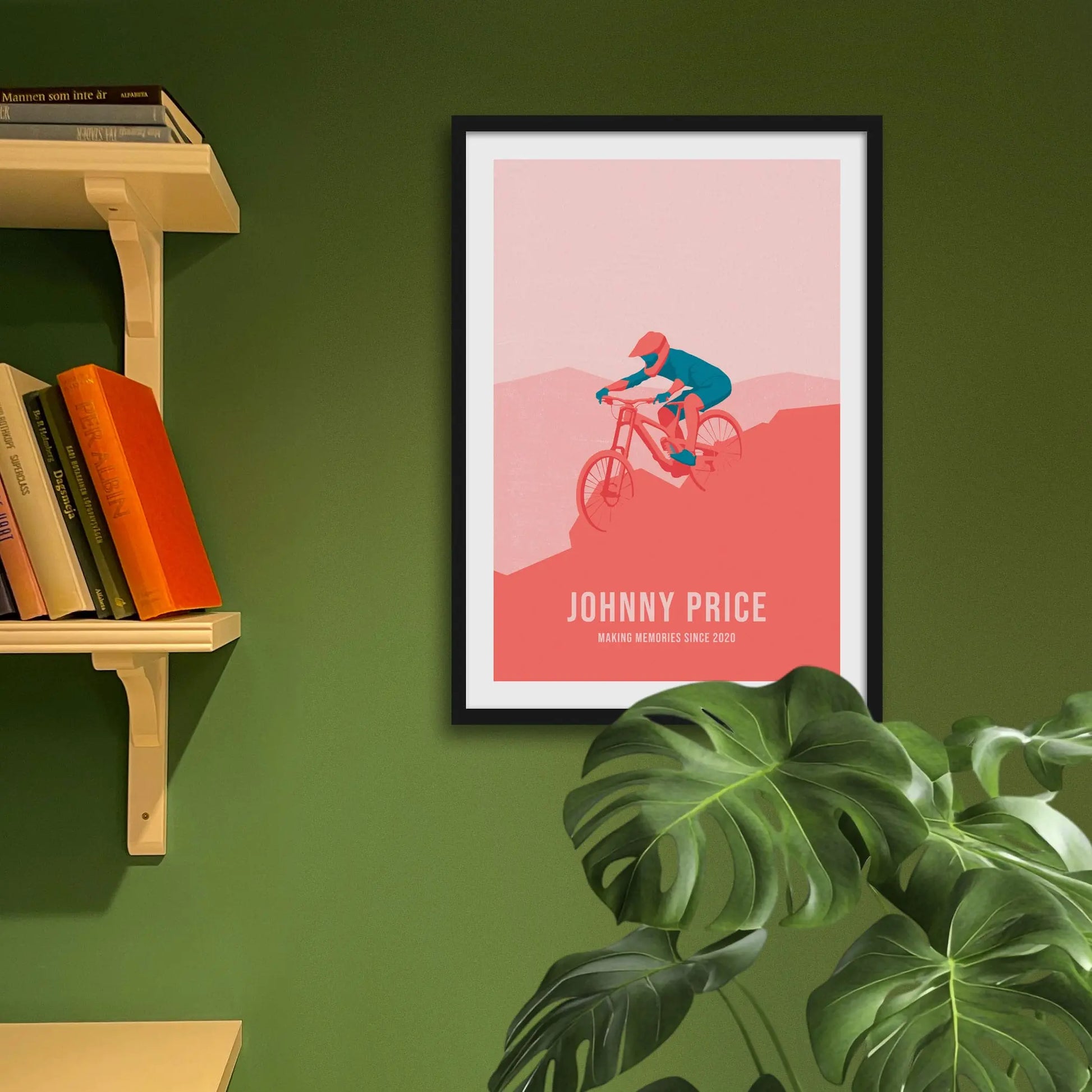 Framed art print on a green wall beside shelves.