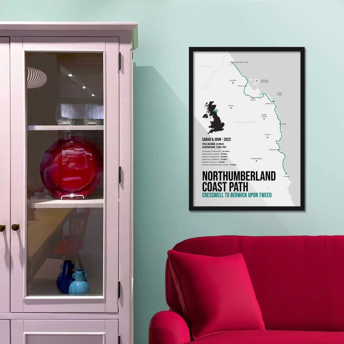 Framed print on wall beside a pink shelving unit