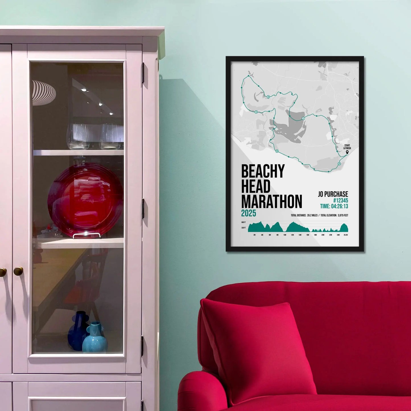 Framed print on light blue wall beside pink shelving