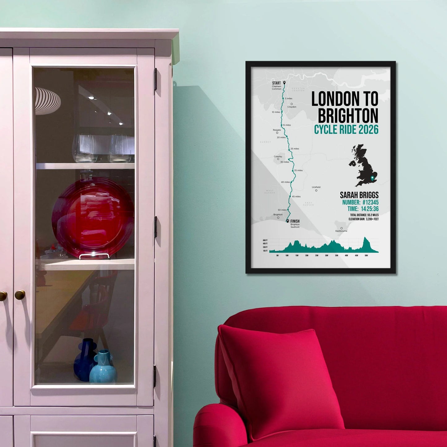 Framed picture on a baby blue wall beside pink shelving