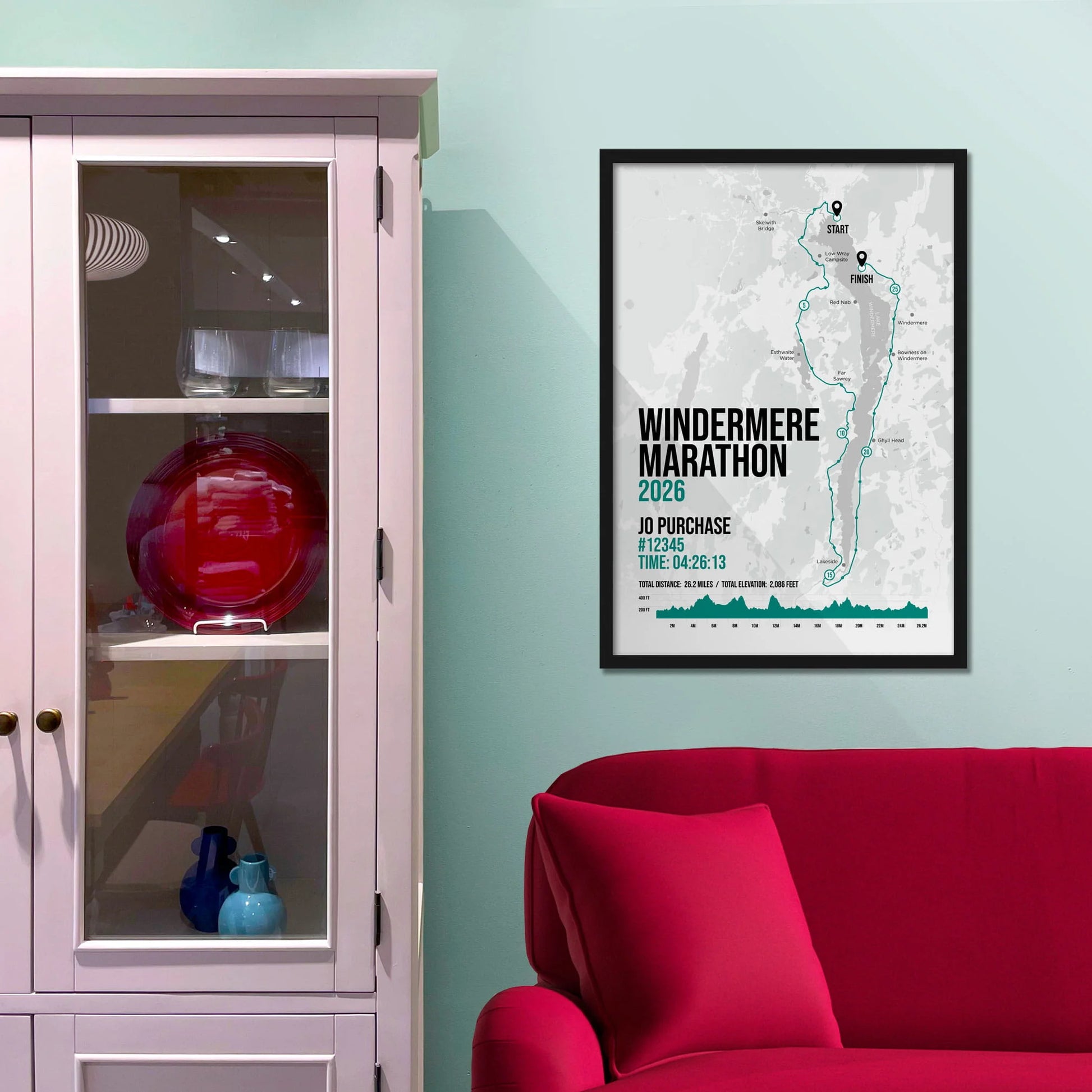 Framed picture on a baby blue wall beside pink shelving