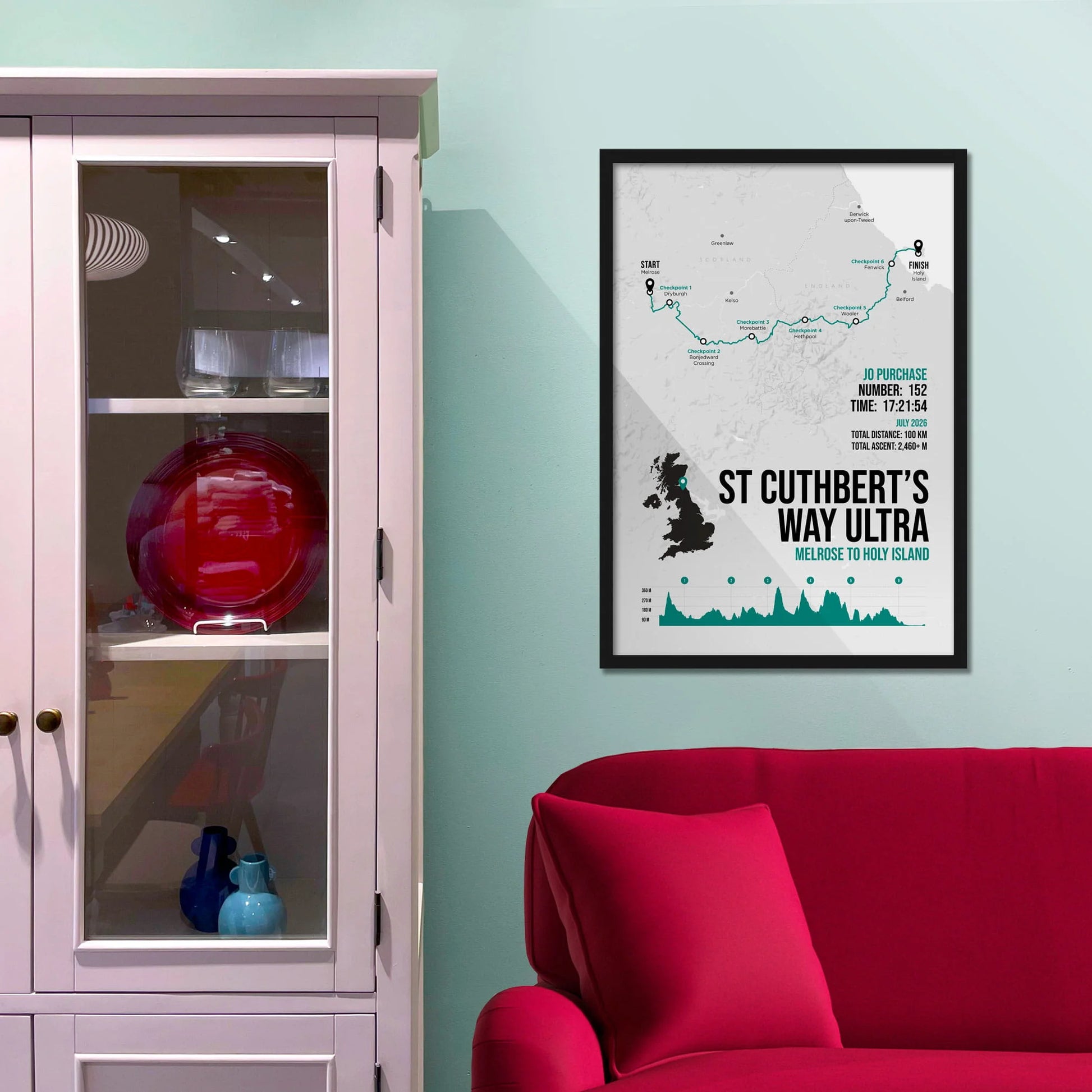 Framed picture on a baby blue wall beside pink shelving