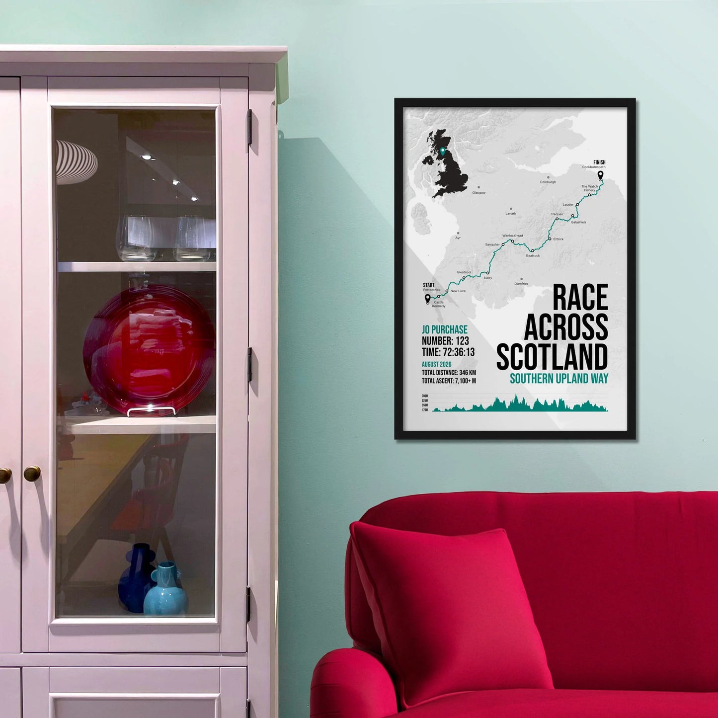 Framed print on light blue wall beside pink shelving unit.