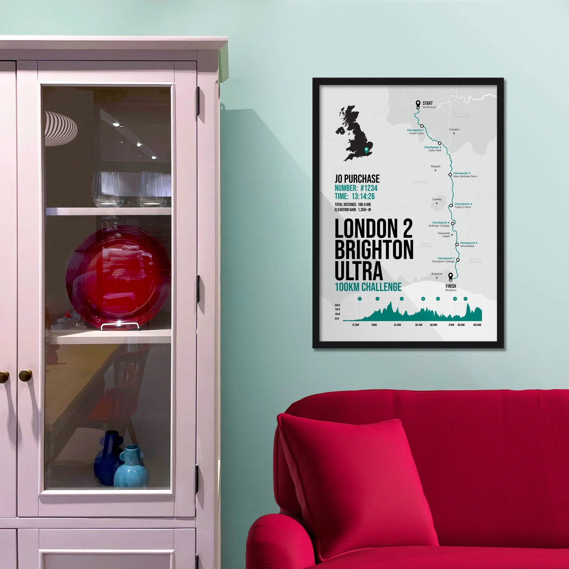 Framed picture on a baby blue wall beside pink shelving