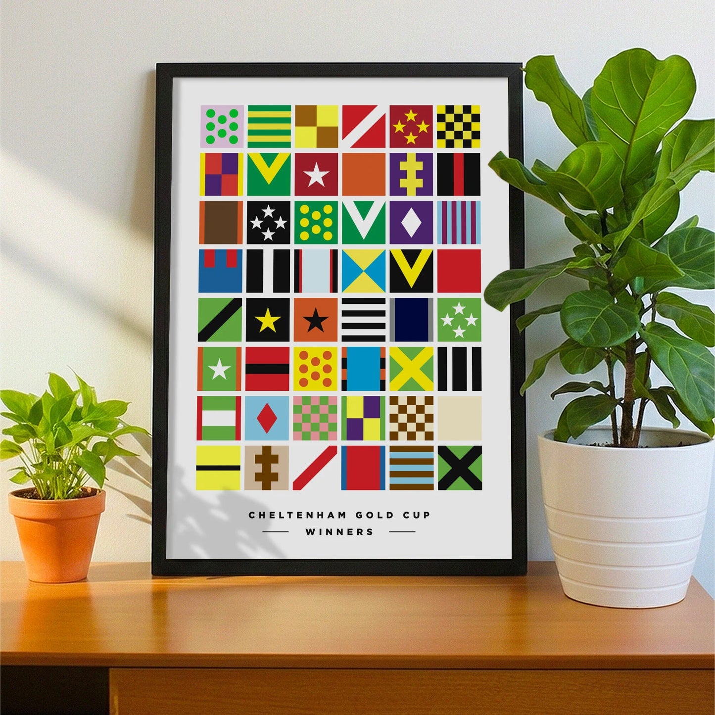 Framed print on sideboard beside a plant