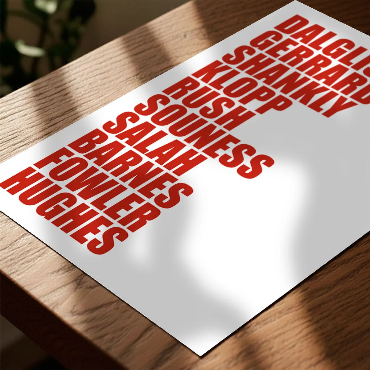 Print laying on table with speckled shade cast across the surface