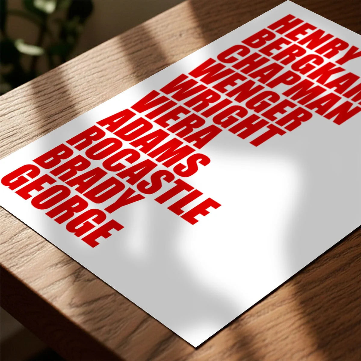 Print laying on table with speckled shade cast across the surface