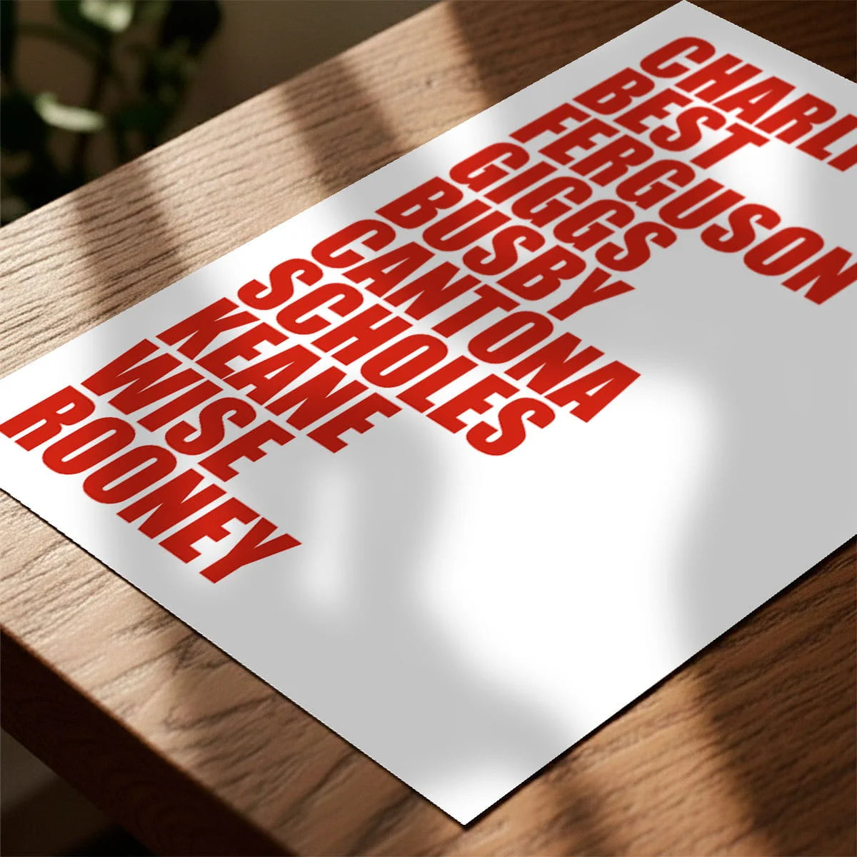 Print laying on table with speckled shade cast across the surface