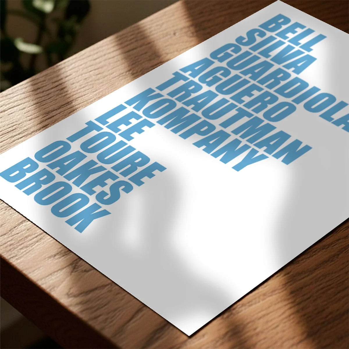 Print laying on table with speckled shade cast across the surface