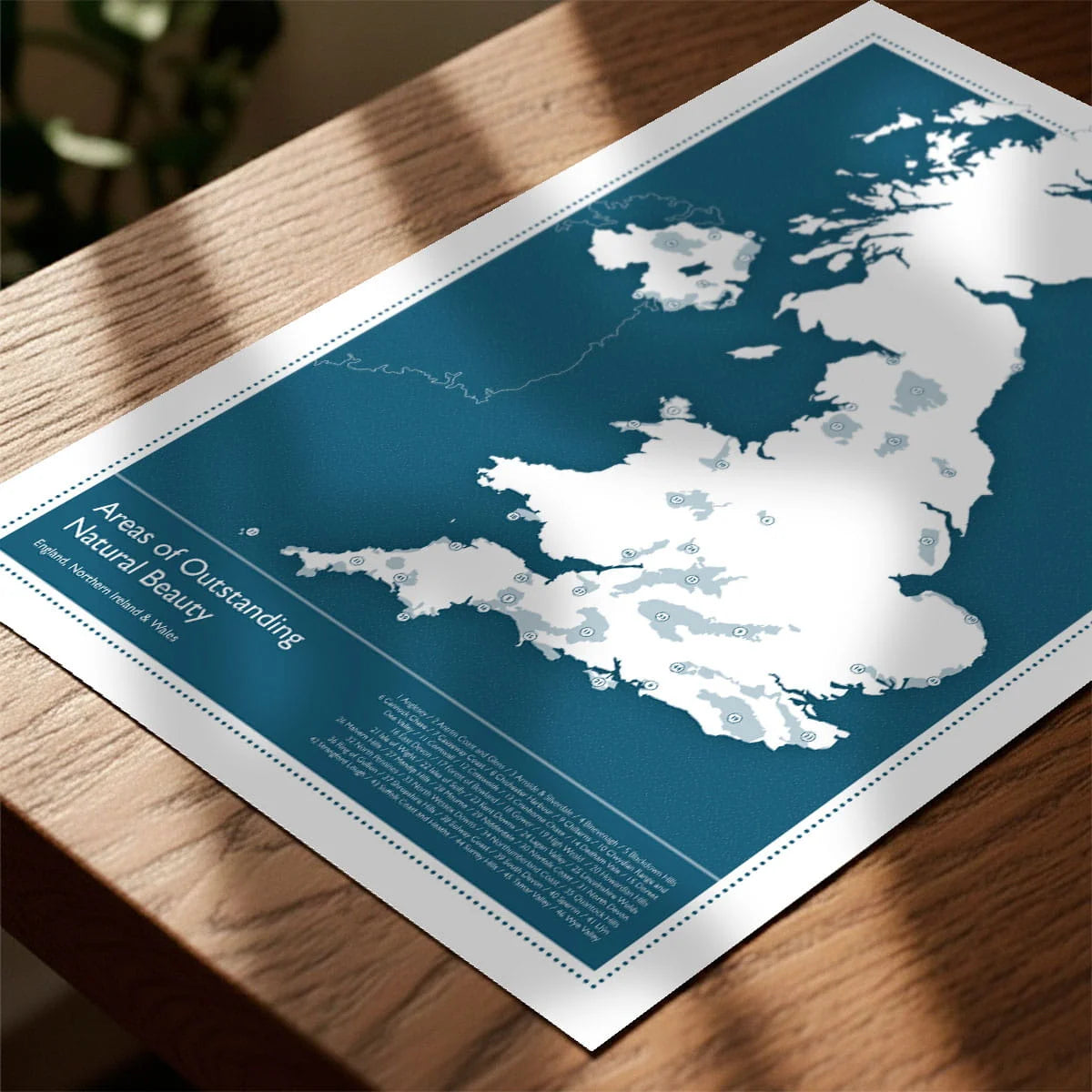 Print laying on table with speckled shade cast across the surface