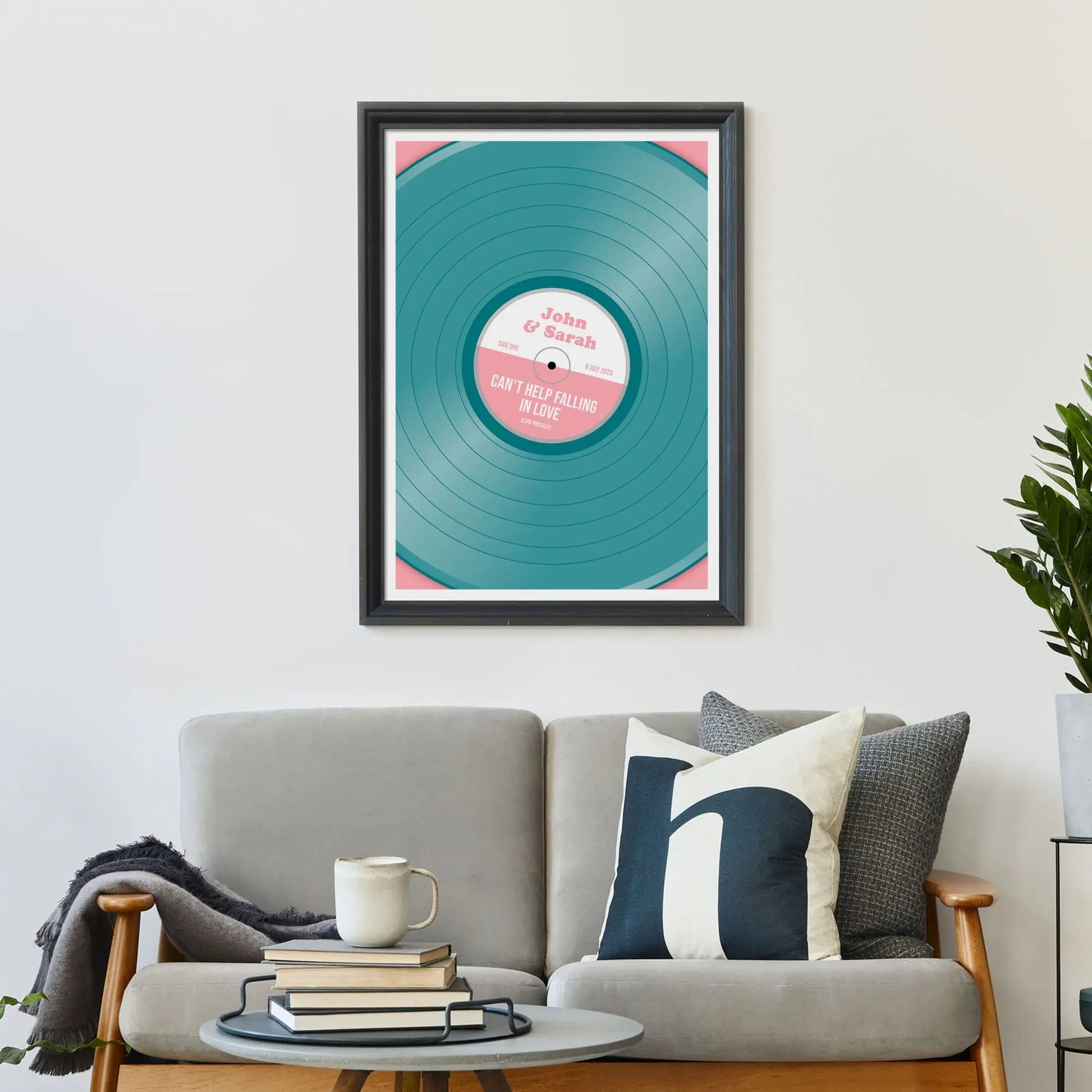 Print on wall above a sofa with cushions